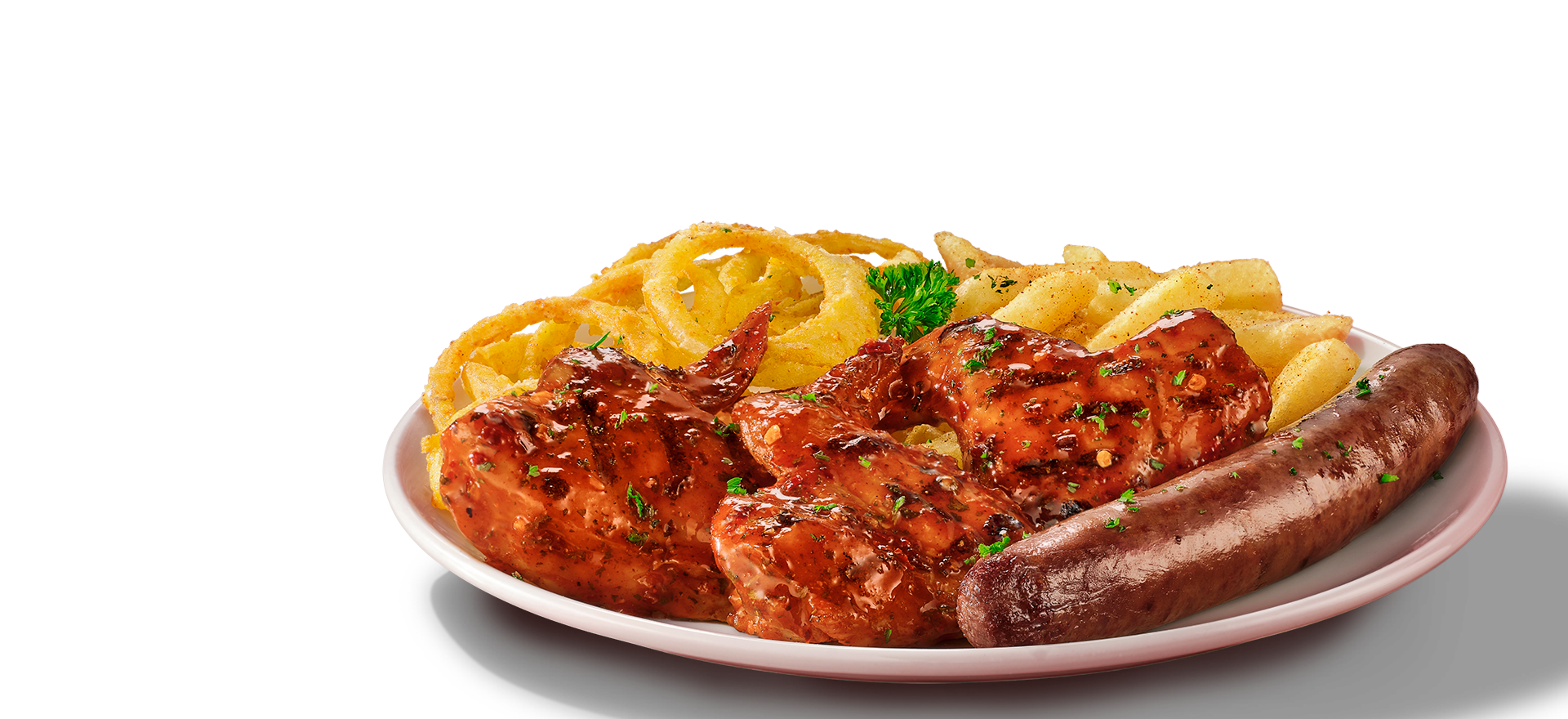Chicken wings and wors with crispy French fries and golden onion rings, garnished with herbs, served on white plate
